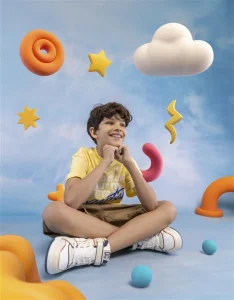 Image of a happy boy sitting and taking advantage of the Independence Day Offers for girls