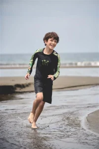 Child running on the beach wearing comfortable kids beachwear